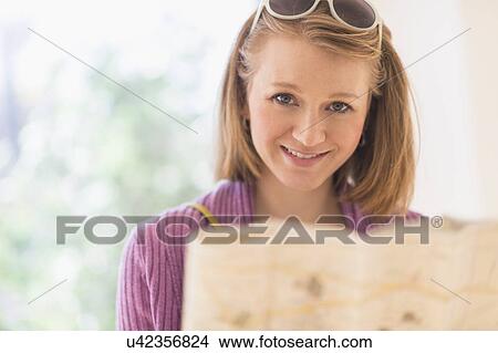 Picture - Portrait of woman holding map. Fotosearch