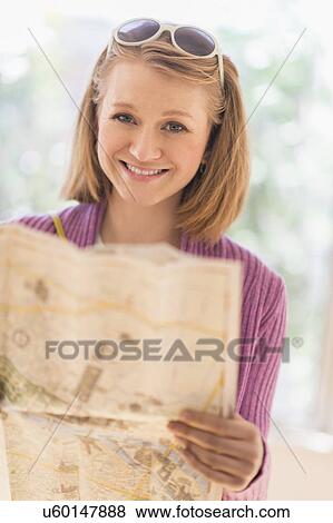 Portrait of woman holding map View Large Photo Image Stock Photo - Portrait of woman holding map. Fotosearch