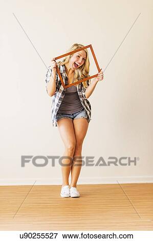 Portrait of woman holding picture frame View Large Photo Image Stock Photo - Portrait of woman holding picture frame. Fotosearch