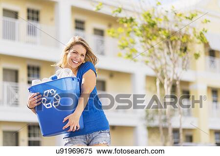 Portrait of woman holding recycling bin View Large Photo Image Stock Photography - Portrait of woman holding recycling bin. Fotosearch
