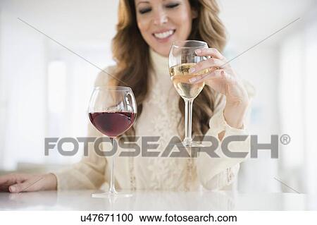 Portrait of woman holding wine glass View Large Photo Image Stock Image - Portrait of woman holding wine glass. Fotosearch