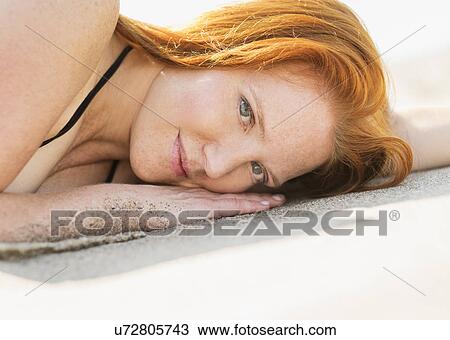 Portrait of woman lying on beach View Large Photo Image Stock Image - Portrait of woman lying on beach. Fotosearch
