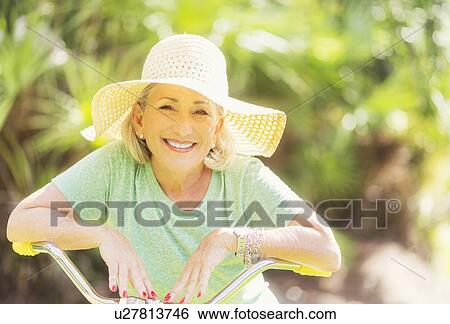 Portrait of woman on bicycle View Large Photo Image Stock Photograph - Portrait of woman on bicycle. Fotosearch