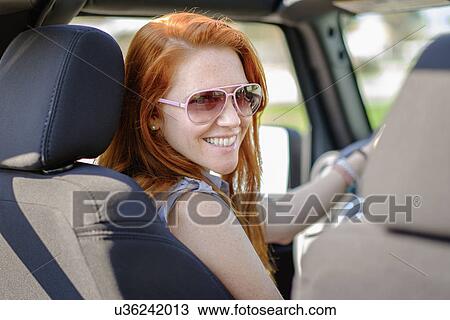 Portrait of woman sitting in car View Large Photo Image Stock Image - Portrait of woman sitting in car. Fotosearch