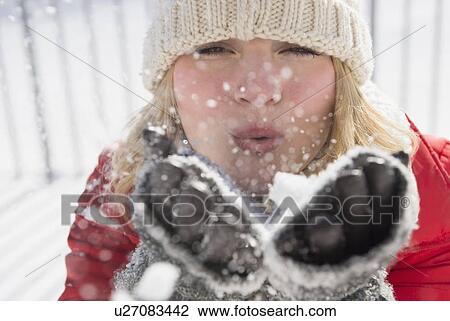 Portrait of woman wearing knit hat blowing snow View Large Photo Image Stock Image - Portrait of woman wearing knit hat blowing snow. Fotosearch