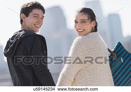 Portrait of young couple walking View Large Photo Image Picture - Portrait of young couple walking. Fotosearch