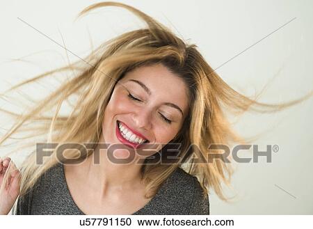 Stock Image - Portrait of young woman dancing. Fotosearch