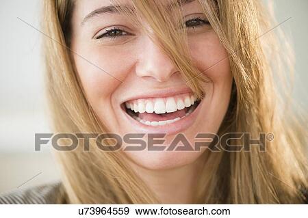 Stock Photo - Portrait of young woman laughing. Fotosearch