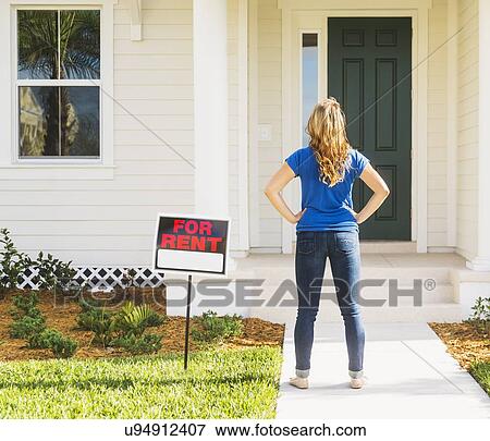 Rear view of woman standing next to for rent sign View Large Photo Image Stock Photo - Rear view of woman standing next to for rent sign. Fotosearch