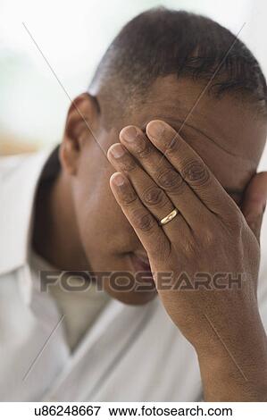 Sad man covering face with hand View Large Photo Image Stock Photo - Sad man covering face with hand. Fotosearch