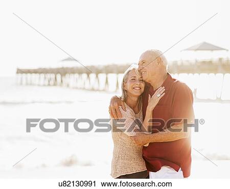 Senior couple embracing on beach View Large Photo Image Stock Image - Senior couple embracing on beach. Fotosearch