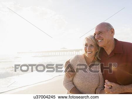 Senior couple embracing on beach View Large Photo Image Stock Photography - Senior couple embracing on beach. Fotosearch