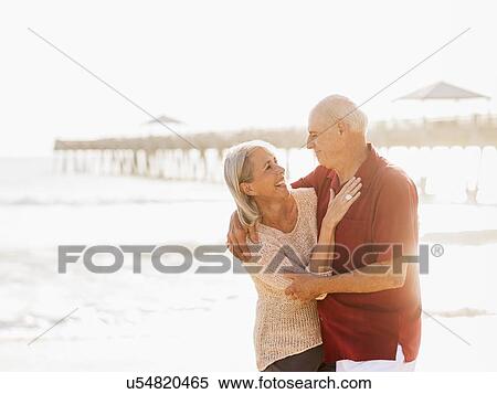 Senior couple embracing on beach View Large Photo Image Stock Photography - Senior couple embracing on beach. Fotosearch