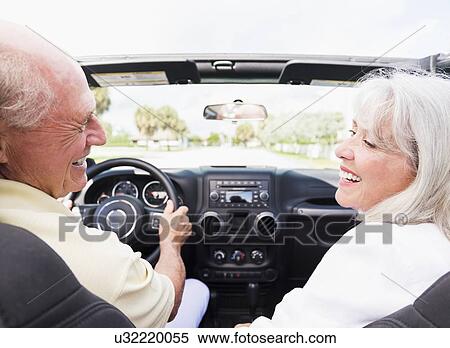 Stock Photography - Senior couple in convertible car. Fotosearch