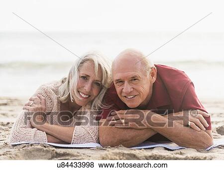 Senior couple lying on beach View Large Photo Image Stock Photo - Senior couple lying on beach. Fotosearch
