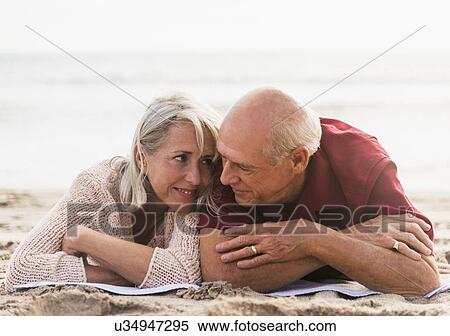 Senior couple lying on beach View Large Photo Image Stock Photography - Senior couple lying on beach. Fotosearch