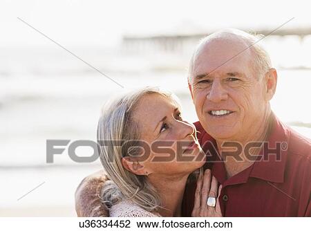 Stock Image - Senior couple on beach. Fotosearch