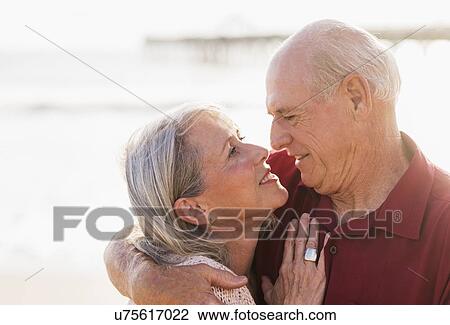 Stock Image - Senior couple on beach. Fotosearch