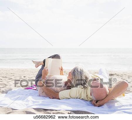 Senior couple reading books on beach View Large Photo Image Stock Image - Senior couple reading books on beach. Fotosearch