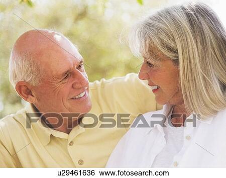 Stock Photograph - Senior couple smiling to each other. Fotosearch