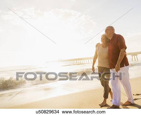 Senior couple walking on beach View Large Photo Image Picture - Senior couple walking on beach. Fotosearch