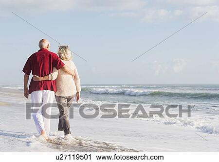 Senior couple walking on beach View Large Photo Image Stock Image - Senior couple walking on beach. Fotosearch