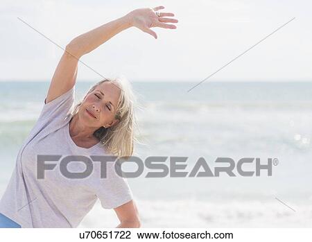 Senior woman exercising on beach View Large Photo Image Stock Image - Senior woman exercising on beach. Fotosearch