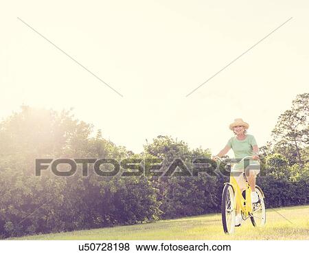 Stock Photo - Senior woman on bike. Fotosearch