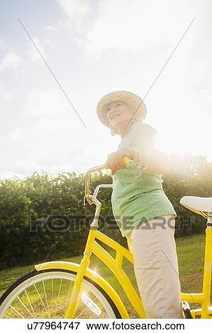 Stock Photo - Senior woman on bike. Fotosearch