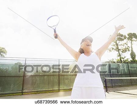 Senior woman on tennis court View Large Photo Image Stock Photograph - Senior woman on tennis court. Fotosearch