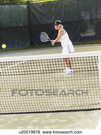 Senior woman playing tennis View Large Photo Image Stock Photo - Senior woman playing tennis. Fotosearch