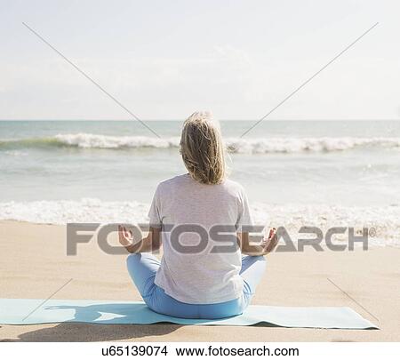 Senior woman practicing yoga on beach View Large Photo Image Picture - Senior woman practicing yoga on beach. Fotosearch