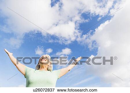 Senior woman with arms outstretched View Large Photo Image Stock Photo - Senior woman with arms outstretched. Fotosearch