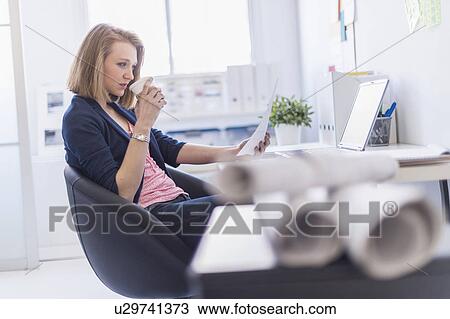Side view of business woman in office View Large Photo Image Stock Image - Side view of business woman in office. Fotosearch