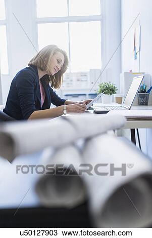 Side view of business woman in office View Large Photo Image Stock Image - Side view of business woman in office. Fotosearch