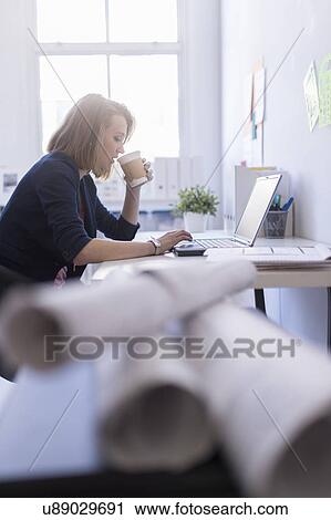 Side view of business woman in office View Large Photo Image Stock Image - Side view of business woman in office. Fotosearch