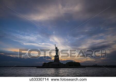 Picture - Silhouette of Statue of Liberty at sunset. Fotosearch