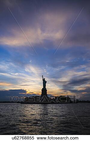 Stock Photography - Silhouette of Statue of Liberty at sunset. Fotosearch