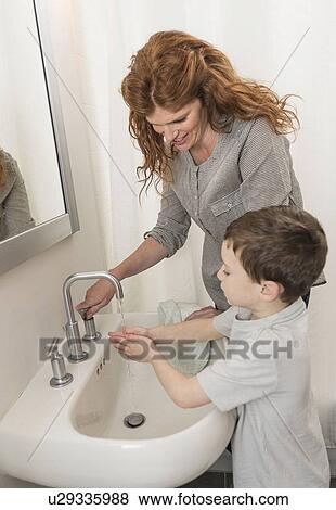 son (6-7) and mother washing hands View Large Photo Image Stock Photo - son (6-7) and mother washing hands. Fotosearch
