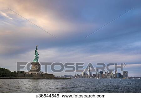 Statue of Liberty with city skyline in background View Large Photo Image Stock Photography - Statue of Liberty with city skyline in background. Fotosearch