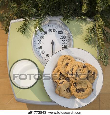 Studio Shot of cookies and milk on bathroom scale View Large Photo Image Stock Image - Studio Shot of cookies and milk on bathroom scale. Fotosearch