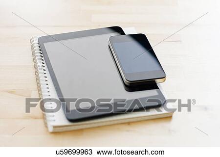 Studio shot of digital tablet, Mobile phone and spiral notebook View Large Photo Image Stock Image - Studio shot of digital tablet, Mobile phone and spiral notebook. Fotosearch