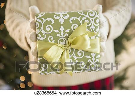 Picture - Studio Shot of female's hands holding gift. Fotosearch