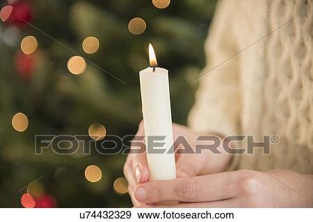 Stock Photo - Studio Shot of female's hands holding candle. Fotosearch