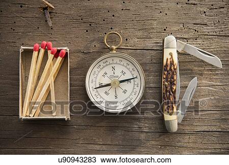 Studio Shot of matchsticks, compass and knife on wooden board View Large Photo Image Stock Image - Studio Shot of matchsticks, compass and knife on wooden board. Fotosearch