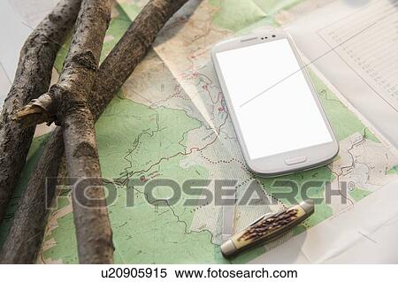 Stock Photography - Studio Shot of mobile phone on map. Fotosearch