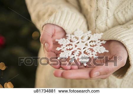 Studio Shot of snowflake on female's hands View Large Photo Image Stock Image - Studio Shot of snowflake on female's hands. Fotosearch