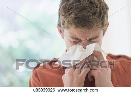 Teenage boy (16-17) blowing nose View Large Photo Image Stock Photograph - Teenage boy (16-17) blowing nose. Fotosearch
