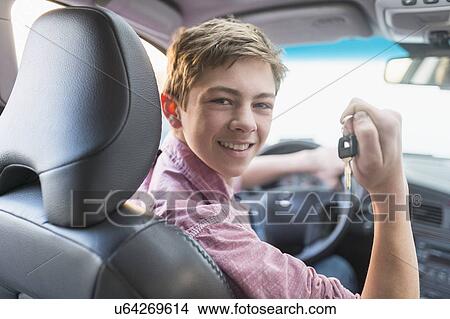 Picture - Teenage boy (16-17) driving his first car. Fotosearch