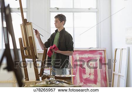 Teenage boy (16-17) painting picture View Large Photo Image Stock Photo - Teenage boy (16-17) painting picture. Fotosearch